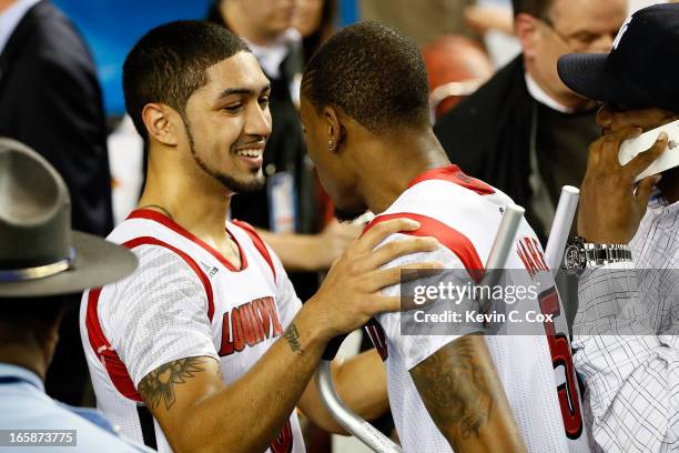 Peyton Siva hugs injured teammate Kevin Ware of the Louisville Cardinals after the Cardinals defeat the Wichita State Shockers 72-68 in the 2013 NCAA...