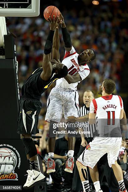 Ehimen Orukpe of the Wichita State Shockers reaches for the ball in the second half against Gorgui Dieng of the Louisville Cardinals during the 2013...