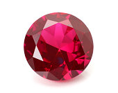 A shiny red ruby gemstone on a white background