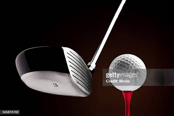 golf clubhead hitting a ball on the tee - golf tee stock pictures, royalty-free photos & images
