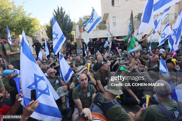 Israeli protesters block the entrance to the residence of Justice Minister Yariv Levin, in the central city of Modiin on September 11 as they protest...