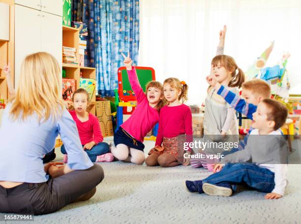 teacher questioning children. - seven point stock pictures, royalty-free photos & images