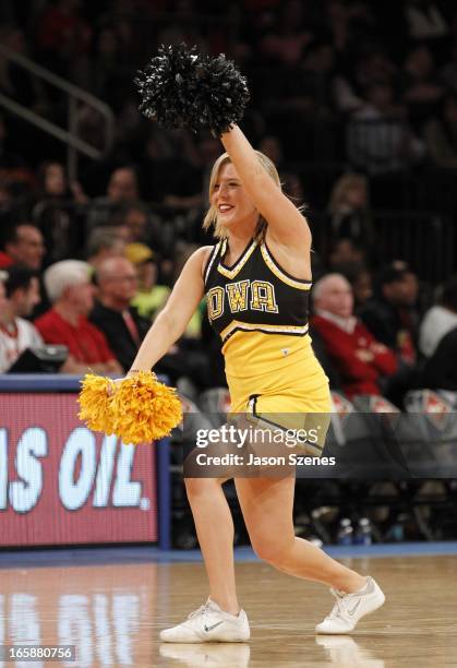 An Iowa Hawkeyes cheerleader in action against the Maryland Terapins in the second half during the 2013 NIT Championship - Semifinals at the Madison...