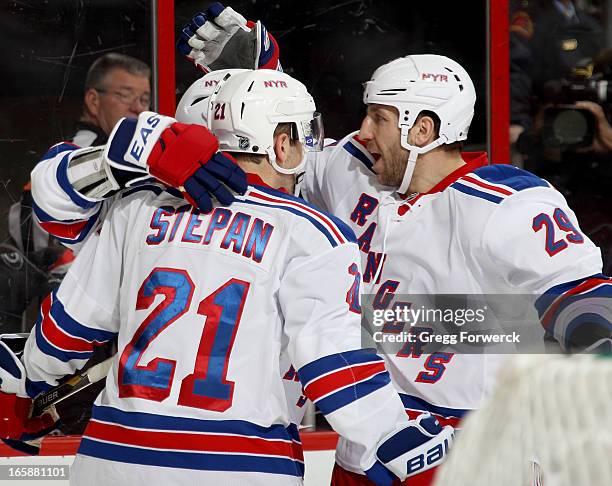 Ryane Clowe of the New York Rangers joins in the celebration of a second-period goal scored by Derek Stepan against the Carolina Hurricanes during...