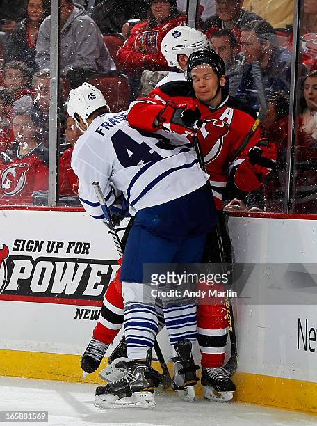 Mark Fraser of the Toronto Maple Leafs checks Patrik Elias of the New Jersey Devils during the game at the Prudential Center on April 6, 2013 in...