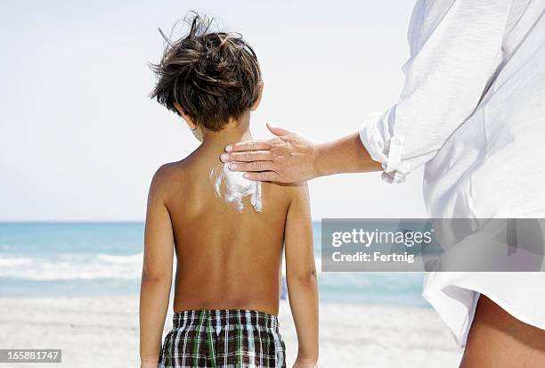 putting on sunscreen - putting lotion stock pictures, royalty-free photos & images