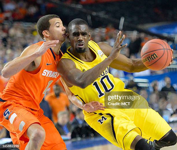 Tim Hardaway Jr. Of the Michigan Wolverines is defended by Michael Carter-Williams of the Syracuse Orange in the second half in an NCAA Final Four...