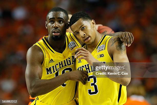 Tim Hardaway Jr. #10 and Trey Burke of the Michigan Wolverines react in the second half against the Syracuse Orange during the 2013 NCAA Men's Final...