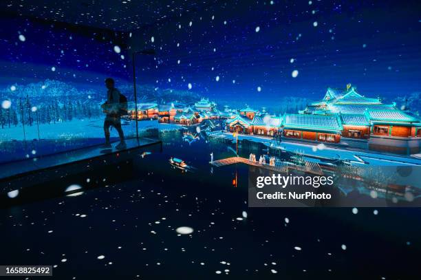 Tourists view a panoramic animation at a digital exhibition hall in Jinling town in Nanjing, East China's Jiangsu province, Sept 10, 2023. The...