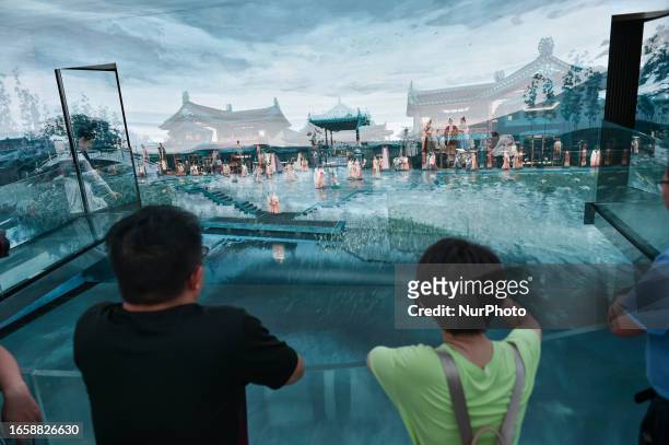 Tourists view a panoramic animation at a digital exhibition hall in Jinling town in Nanjing, East China's Jiangsu province, Sept 10, 2023. The...