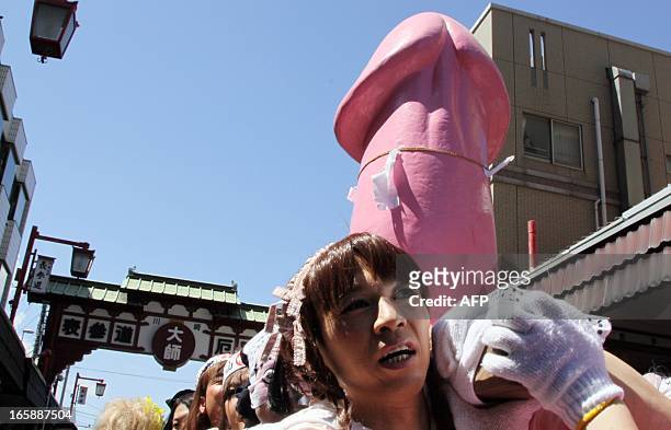 People carry a phallus-shape portable shrine outside the Kanayama shrine during the Kanamara festival in Kawasaki, Kanagawa prefecture, on April 7,...