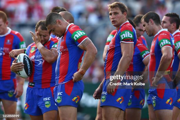 The Knights players stand dejected after a Dragons try during the round five NRL match between the St George Illawarra Dragons and the Newcastle...