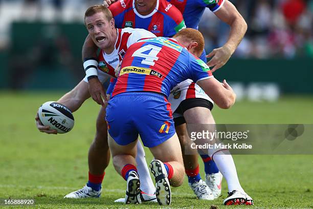 Ben Creagh of the Dragons gets a pass away as he is tackled during the round five NRL match between the St George Illawarra Dragons and the Newcastle...