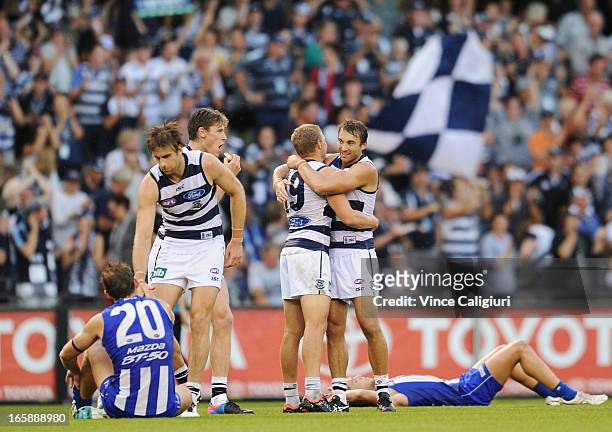 Taylor Hunt and Corey Enright of the Cats hug after the final siren during the round two AFL match between the Geelong Cats and the North Melbourne...