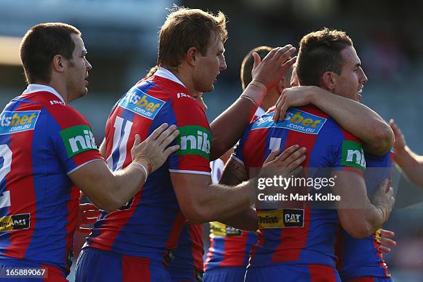 Darius Boyd of the Knights is congratulated by him team after scoring a try during the round five NRL match between the St George Illawarra Dragons...