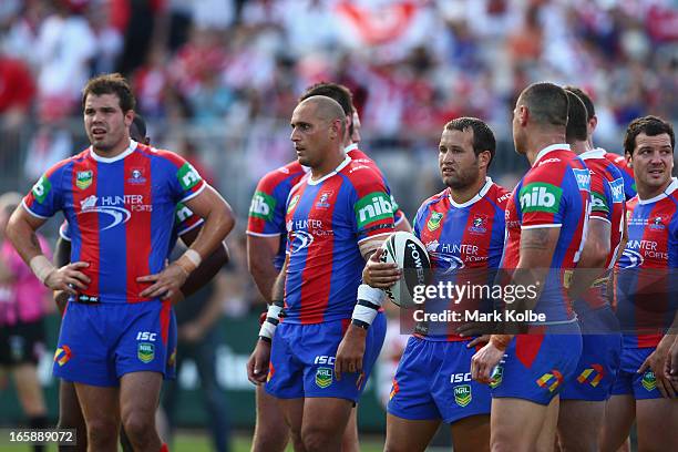 The Knights players stand dejected after a Dragons try during the round five NRL match between the St George Illawarra Dragons and the Newcastle...