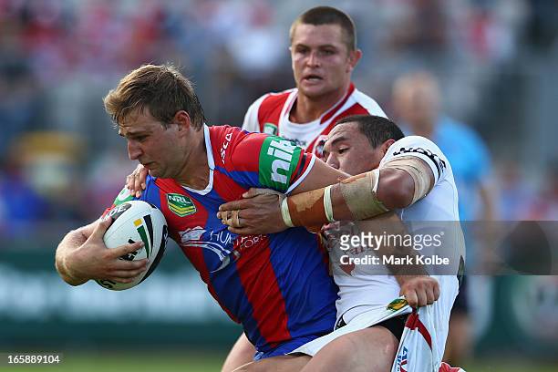 Robbie Rochow of the Knights is tackled during the round five NRL match between the St George Illawarra Dragons and the Newcastle Knights at WIN...