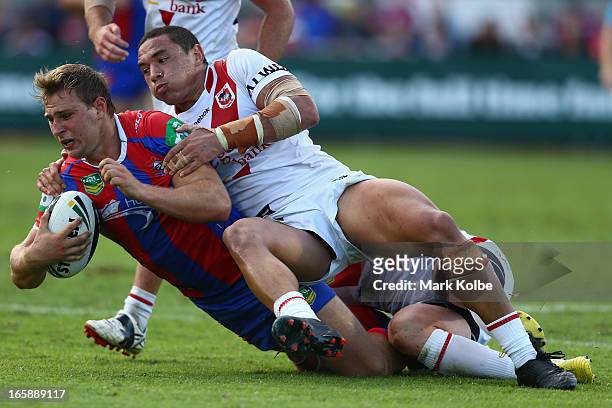 Robbie Rochow of the Knights is tackled during the round five NRL match between the St George Illawarra Dragons and the Newcastle Knights at WIN...