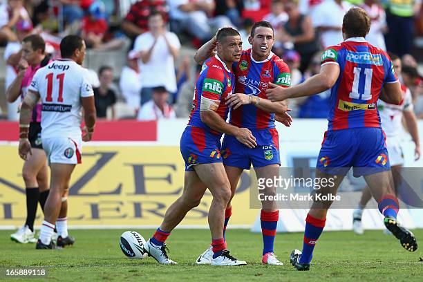 Timana Tahu of the Knights is congratulated by Darius Boyd of the Knights after scoring a try during the round five NRL match between the St George...