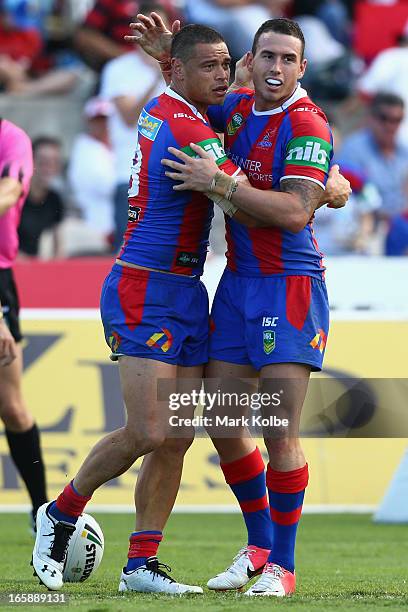 Timana Tahu of the Knights is congratulated by Darius Boyd of the Knights after scoring a try during the round five NRL match between the St George...