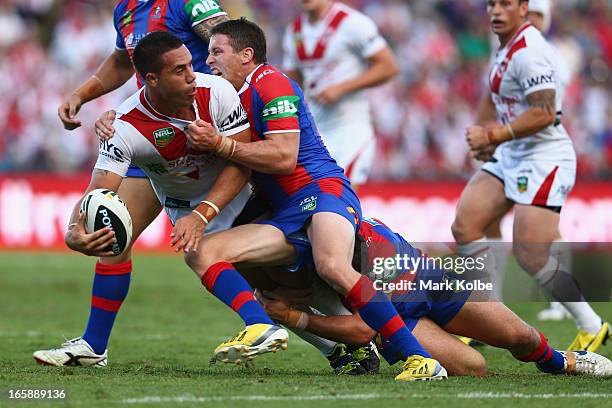 Bronson Harrison of the Dragons gets a pass away as he is tackled during the round five NRL match between the St George Illawarra Dragons and the...