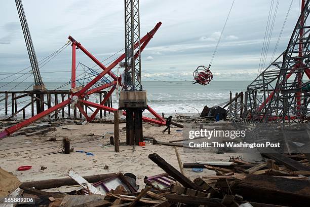 Police officer walks through the debris of the Funtown Pier in Seaside Park, NJ on Nov. 1. The pier and amusement park was destroyed by Hurricane...