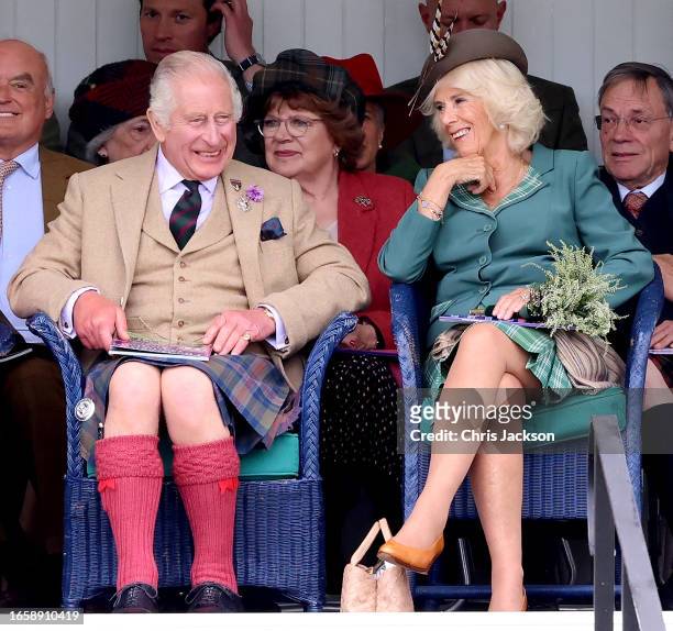 King Charles III and Queen Camilla laugh as they attend The Braemar Gathering 2023 at The Princess Royal and Duke of Fife Memorial Park on September...