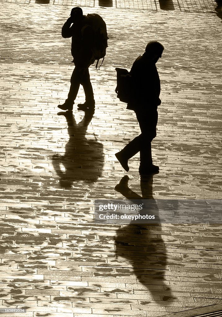 Two Men In Shadow Two Men And Shadow High-Res Stock Photo - Getty Images