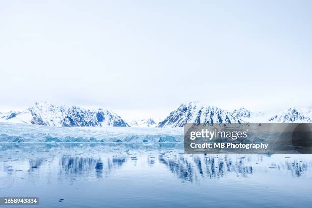 dramatic reflection in svalbard. - svalbard stock pictures, royalty-free photos & images