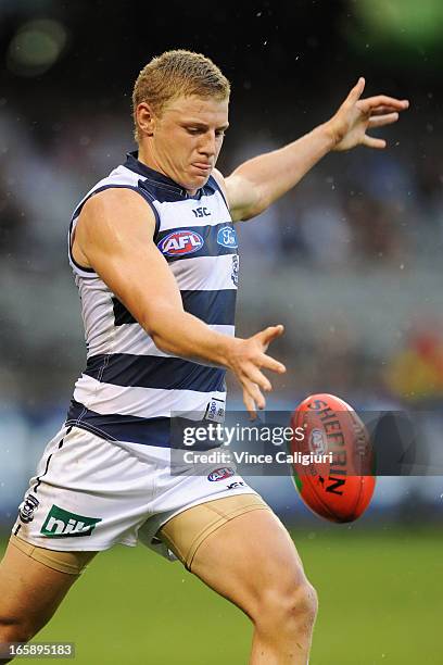 Taylor Hunt of the Cats kicks the ball during the round two AFL match between the Geelong Cats and the North Melbourne Kangaroos at Etihad Stadium on...