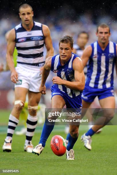 Andrew Swallow of the Kangaroos chases for the ball during the round two AFL match between the Geelong Cats and the North Melbourne Kangaroos at...