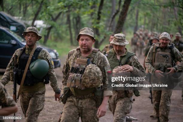 Ukrainian soldiers come back from military exercises on a military outdoor firing range on July 4, 2023 in Donetsk Oblast, Ukraine.