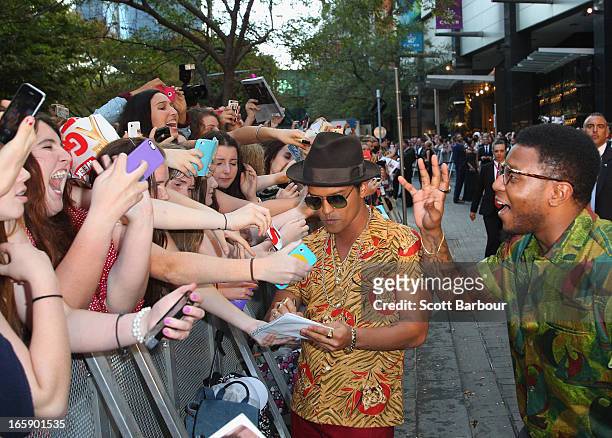 Musician Bruno Mars signs autographs for fans as he arrives at the 2013 Logie Awards at the Crown on April 7, 2013 in Melbourne, Australia.