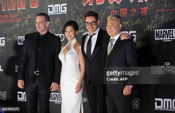 This picture taken on April 6, 2013 shows Hollywood actor Robert Downey Jr. Posing with CEO of DMG Dan Mintz , DMG president Wu Bing and DMG chairman...