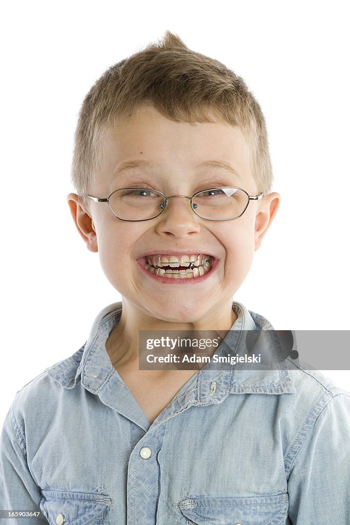 Smiling smiling boy with braces isolated on white