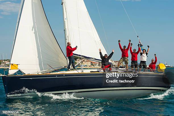 sailing crew celebrating the victory - sailing teamwork stock pictures, royalty-free photos & images