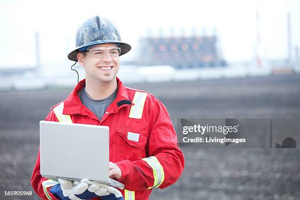 industrial worker in a red uniform - red jumpsuit stock pictures, royalty-free photos & images