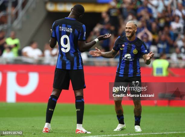 Marcus Thuram of FC Internazionale celebrates with his team-mate Federico Dimarco after scoring the team's first goal during the Serie A TIM match...