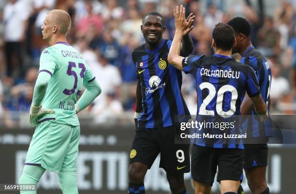 Marcus Thuram of FC Internazionale celebrates with his team-mate Hakan Calhanoglu after scoring the team's first goal during the Serie A TIM match...