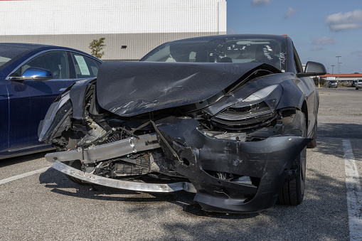 Wrecked Tesla Model 3 Electric Vehicle. A Tesla EV may cost more to insure due to the specialized tools and parts required.