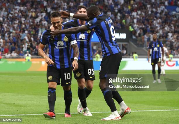 Lautaro Martinez of FC Internazionale celebrates with his team-mates Marcus Thuram and Alessandro Bastoni after scoring the team's second goal during...
