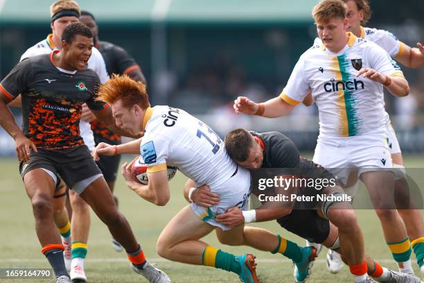 Rayn Smid of Ealing Trailfinders tackles George Hendy of Northampton Saints during the Premiership Rugby Cup match between Ealing Trailfinders and...