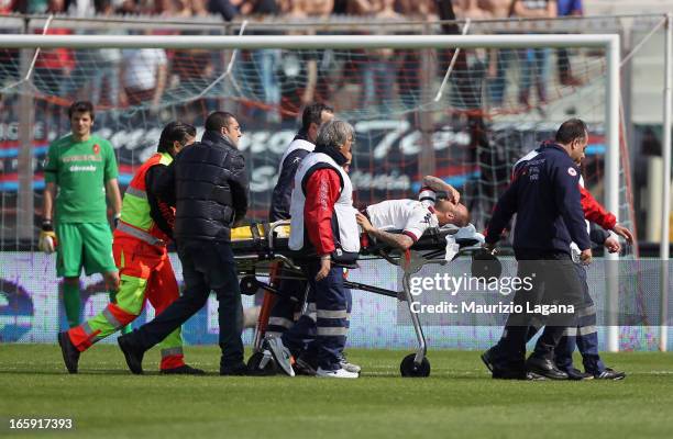 Francesco Pisano of Cagliari is carried off the pitch after suffering an injury during the Serie A match between Calcio Catania and Cagliari Calcio...