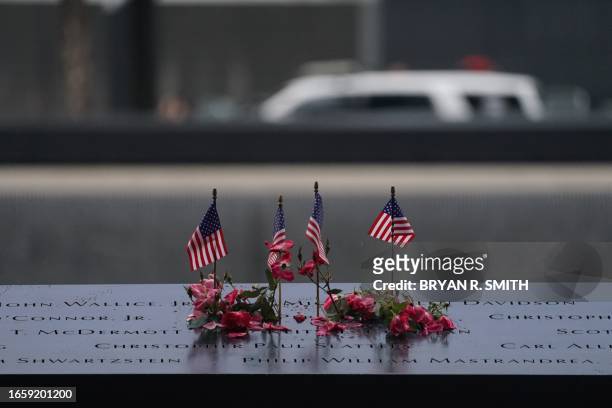 American flags and flowers line the memorial pool at the National September 11 Memorial to mark the 22nd anniversary of the 9/11 terror attack at the...