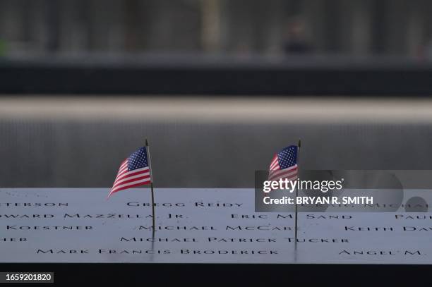 American flags line a memorial pool at the National September 11 Memorial to mark the 22nd anniversary of the 9/11 terror attack at the World Trade...