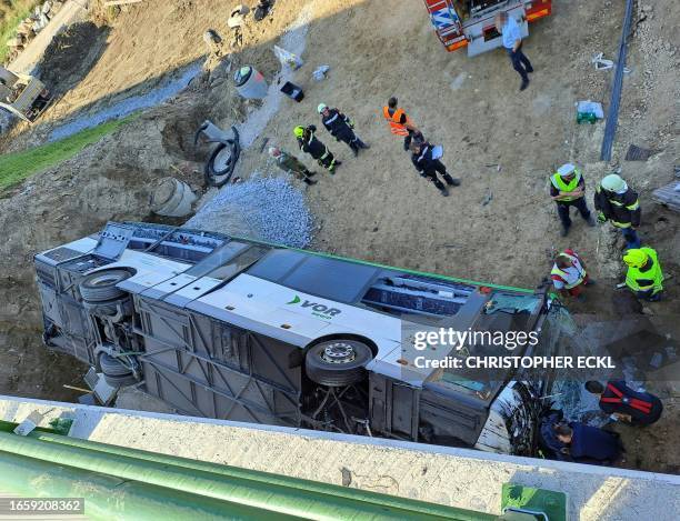 Rescuers work at the site of a road accident in the district of Krems, Lower Austria, on September 11, 2023. A public bus veered off a bridge on...