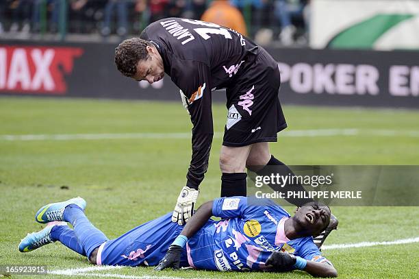 Evian's Ghanaian midfielder Mohammed Rabiu is injured during the French L1 football match Saint-Etienne vs Evian Thonon-Gaillard on April 7, 2013 at...