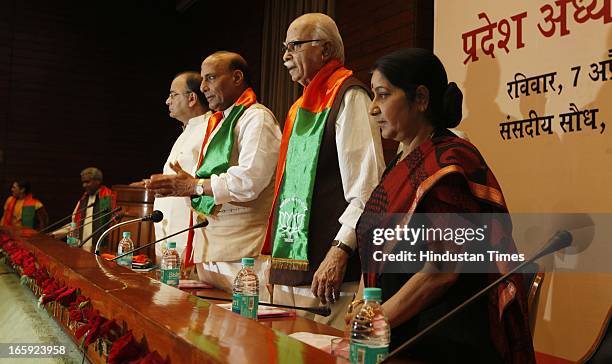 President Rajnath Singh with party leaders LK Advani and Sushama swaraj during first meeting of newly-appointed office bearers of the party on April...