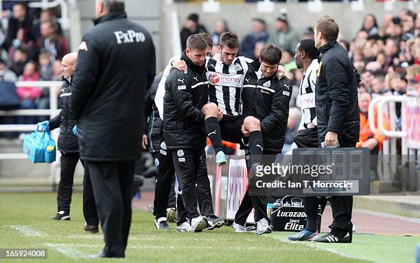 Davide Santon of Newcastle United is carried off injured during the Barclays Premier League match between Newcastle United and Fulham at St James'...