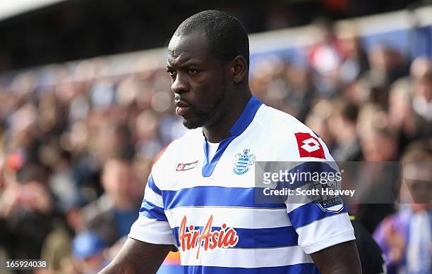 Christopher Samba of Queens Park Rangers walks onto the pitch ahead of the Barclays Premier League match between Queens Park Rangers and Wigan...